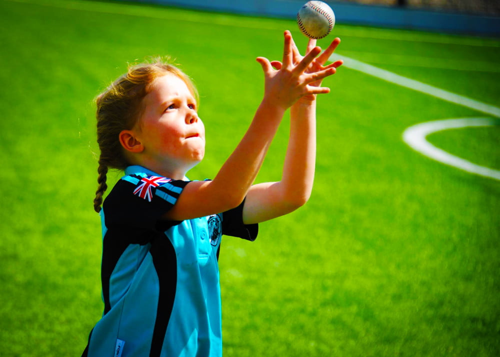 Photograph of Primary phase student reaching for the ball whilst playing sport at NNord Anglia International School Dubai