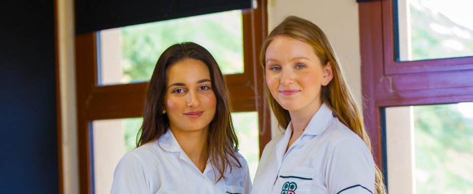 Young women at Raha School International in uniform looking serenely happy - awarded one of the top 20 Best Schools in Dubai and Abu Dhabi by schoolscompared.com in 2017