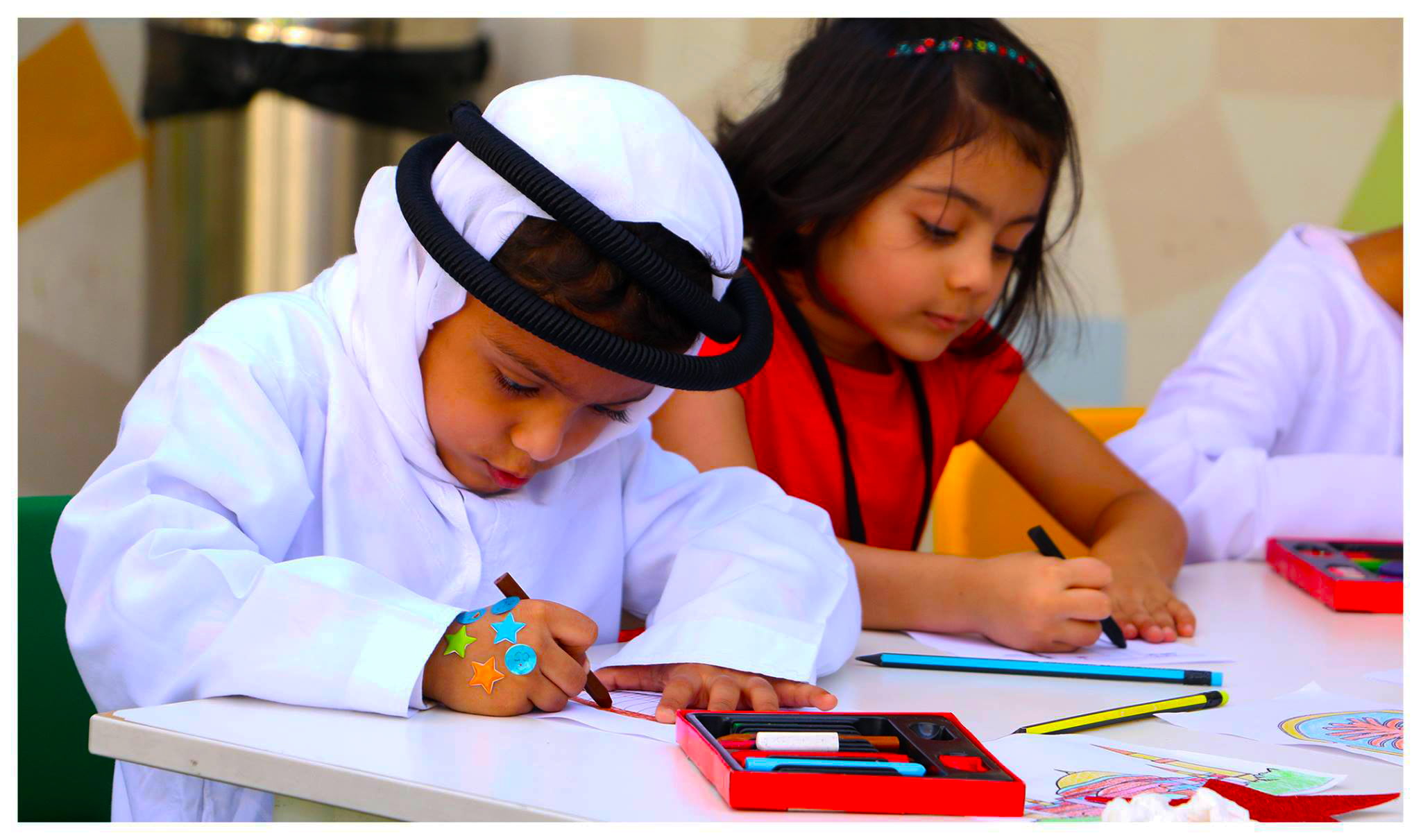 Photograph of children at the Ambassador Kindergarten and Nursery in Dubai engaged in art-based learning to develop creativity and fine motoring skills