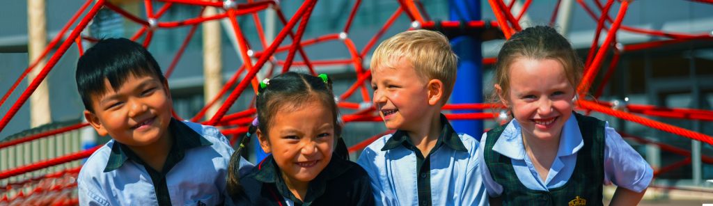 أطفال يضحكون في مدرسة الملوك ند الشبا باستخدام معدات اللعب وإطارات التسلق