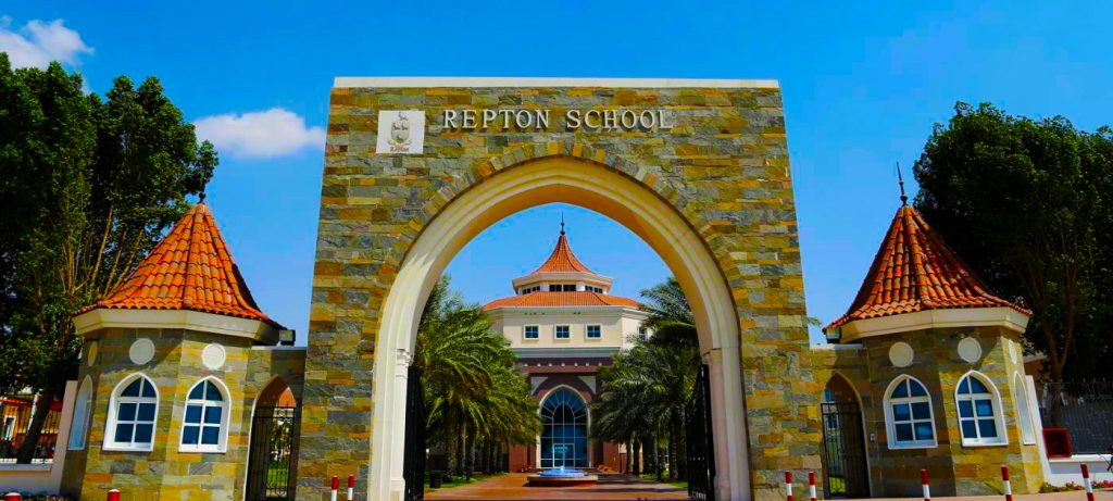 A photograph of the Gates at Repton School Dubai looking in on the Fountain and Main Courtyard - highlighting just how architecturally different the school is from its founding school in the UK