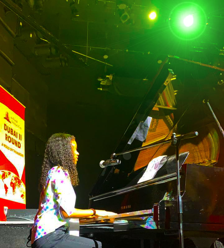 Photograpg of Star International School Al Twar stuent playing the grand piano as part of an inter-school competition in Dubai