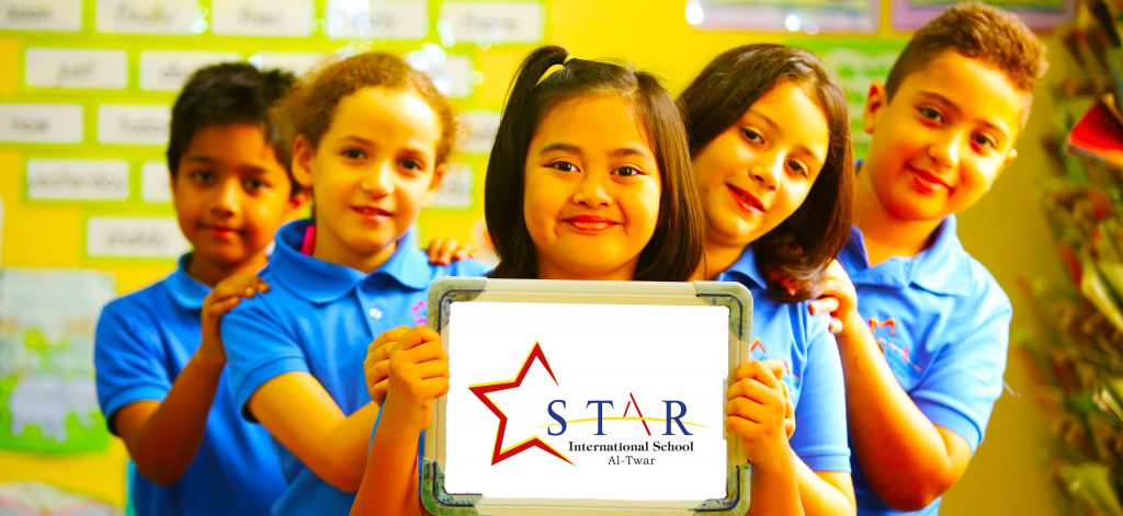 Children at Star International School Al Twar celebrating their school at the End of Year Awards Presentation