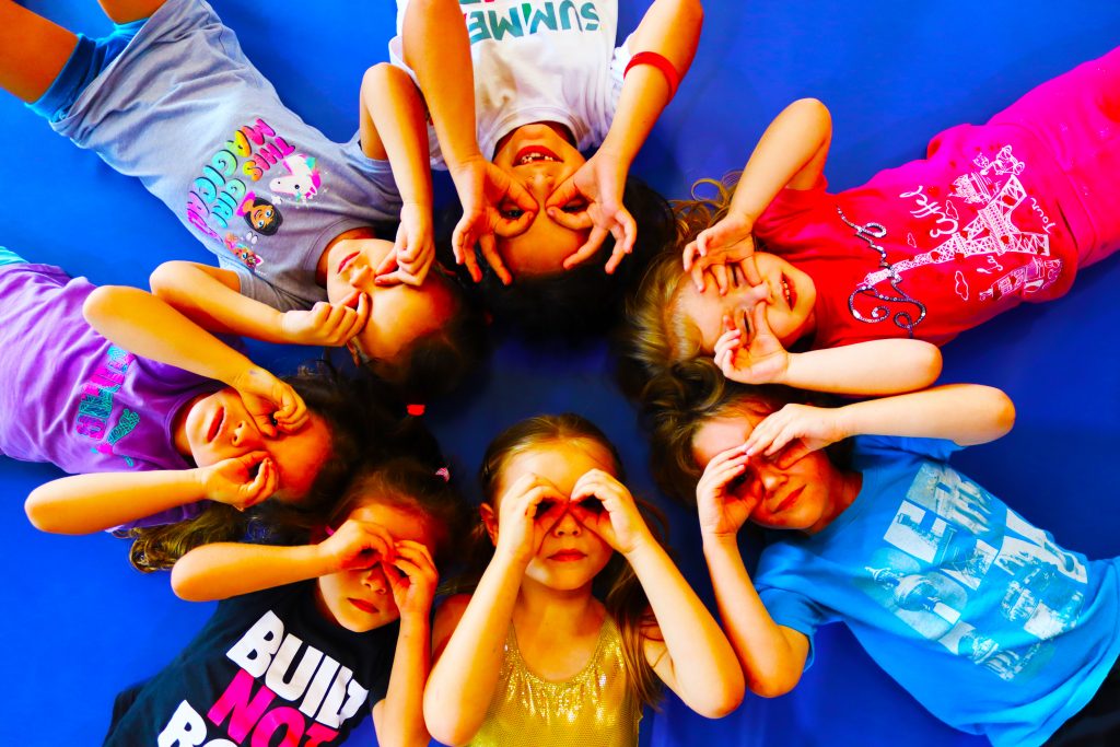 Schools Out! Top 25 Guide to What's On and What to Do in the Summer Holidays showing children looking up training at the Fly High Summer Camp in Dubai UAE.