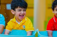 Photograph of young children engaged in water play as part of EYFS British English national Curriculum learning at Al Forsan Nursery school in Abu Dhabi
