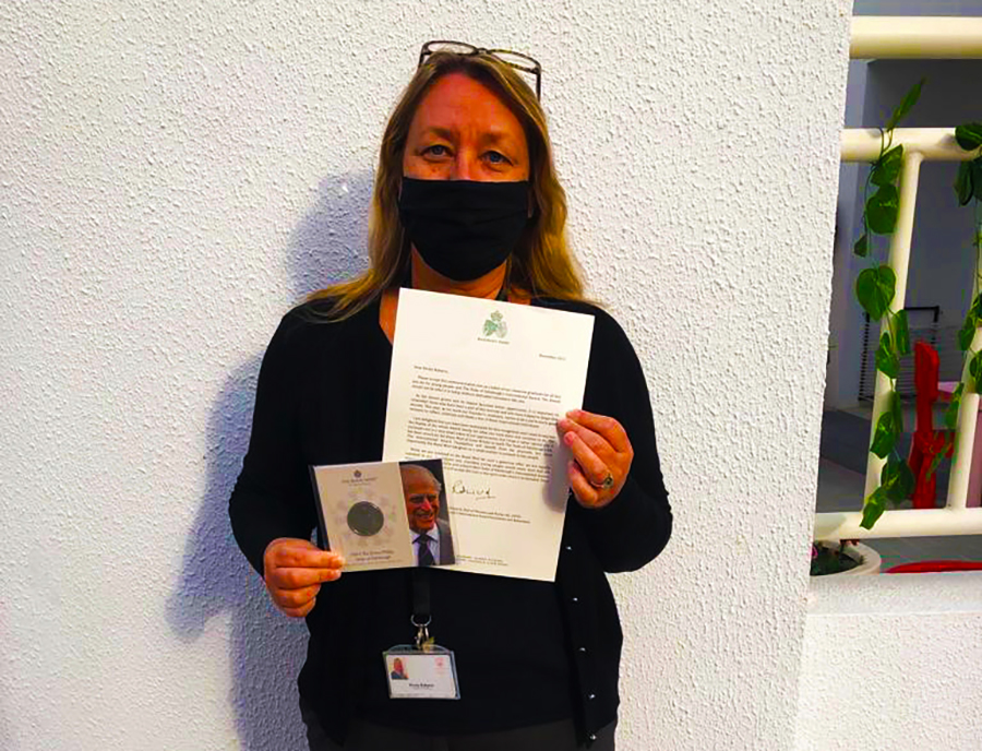 Photograph of Kirsty Roberts, proud recipient of major award from UK Royal Families Duke of Edinburgh. Here we see Miss Roberts pictured with her Award at her school: The English College Dubai