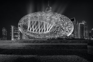 Black and white photograph of Dubai's Museum of the Future including its lighting and calligraphy at night