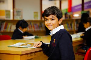 Photograph of a child in the library at Raffles International School in Dubai